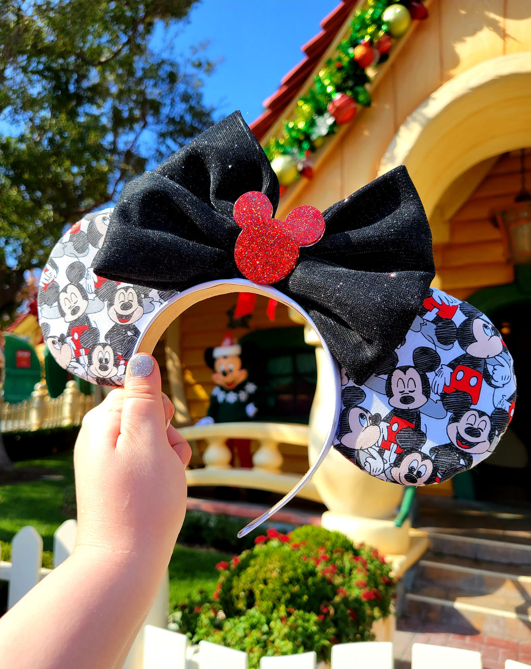 Mickey Mouse ears with black sparkle bow and red Mickey silhouette embellishment