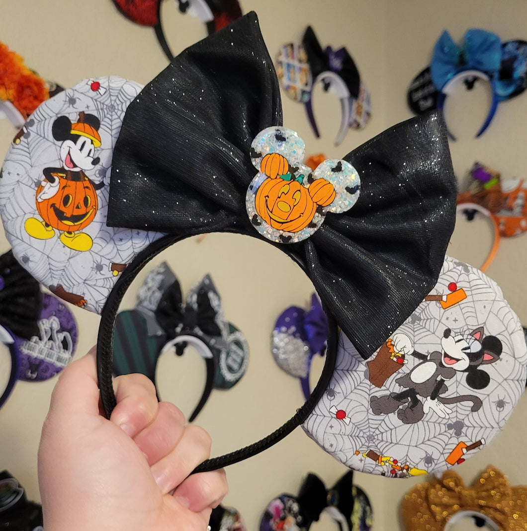 Disney couples in their Halloween  costume ears